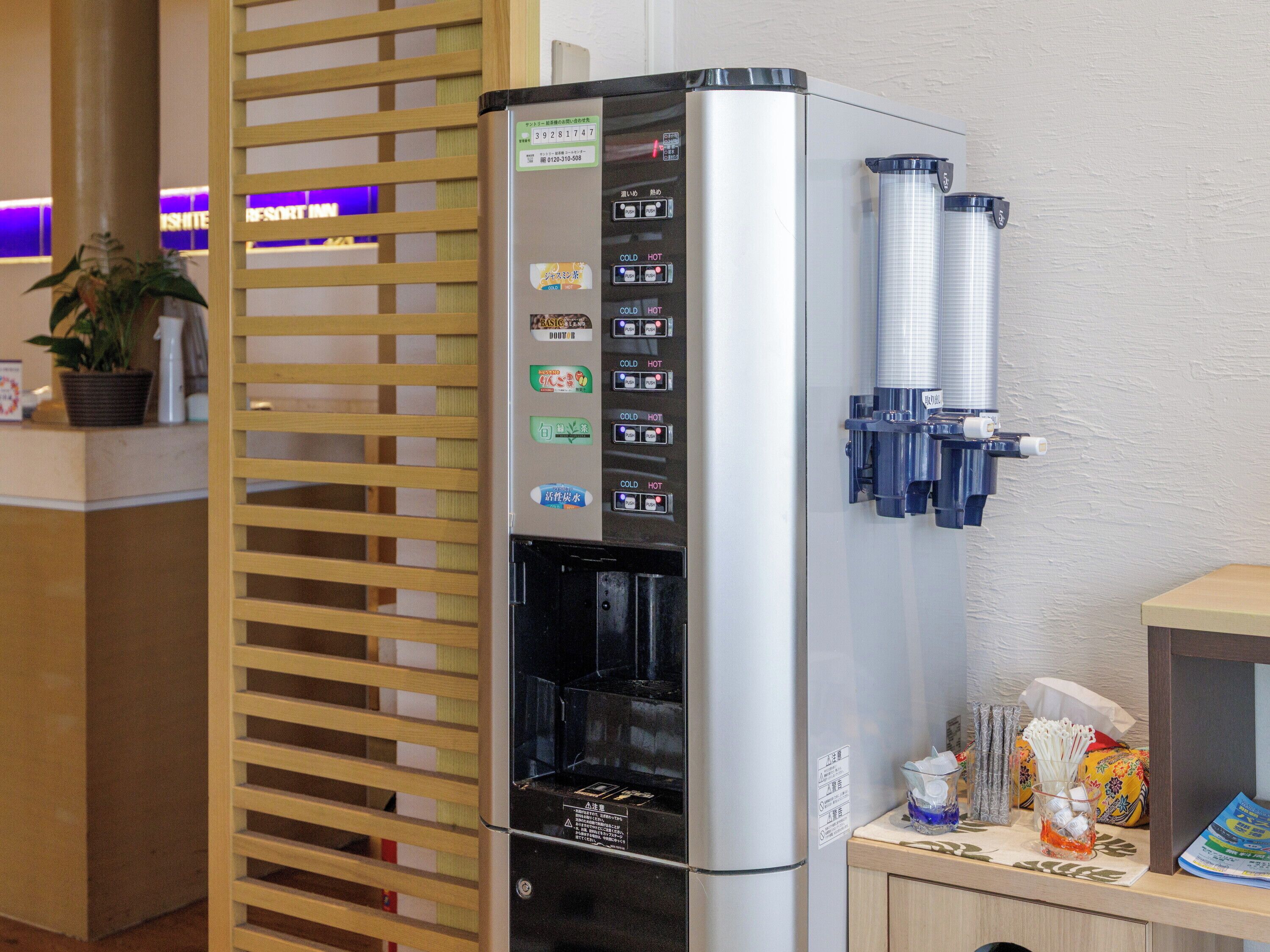 A water dispenser with multiple drink options and a coffee machine.