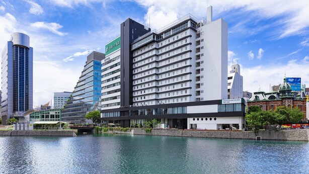 A modern hotel with a glass facade, multiple floors, and a rooftop terrace. - Nishitetsu Inn Fukuoka (Fukuoka)