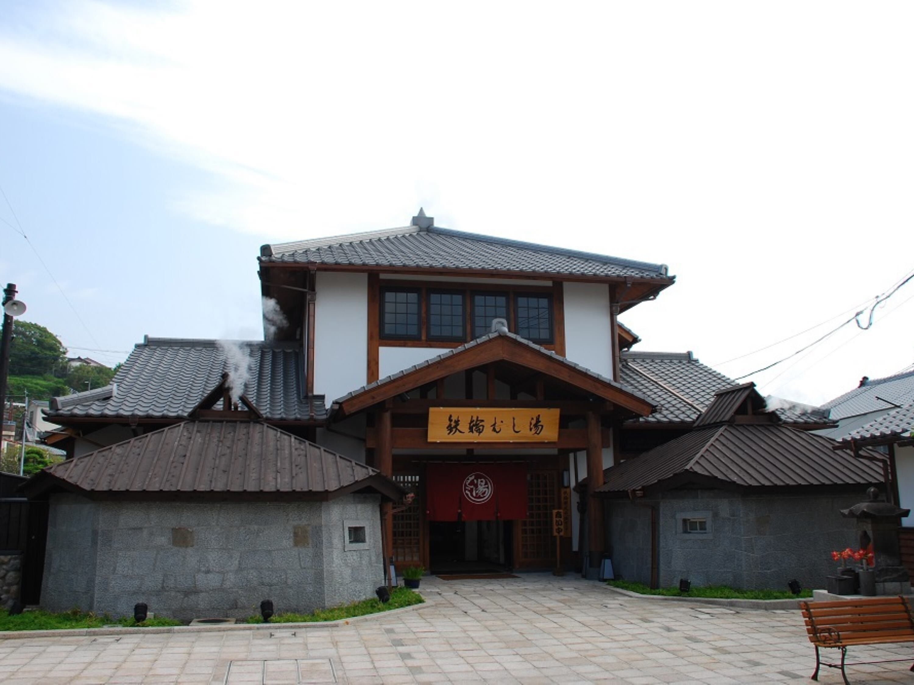 A traditional building with a tiled roof and a wooden entrance.