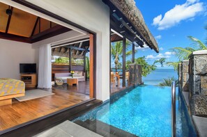 A modern hotel room with a large glass window overlooking a pool and ocean. - Le Jadis Beach Resort & Wellness - Managed by Banyan Tree Hotels & Resorts (Balaclava)