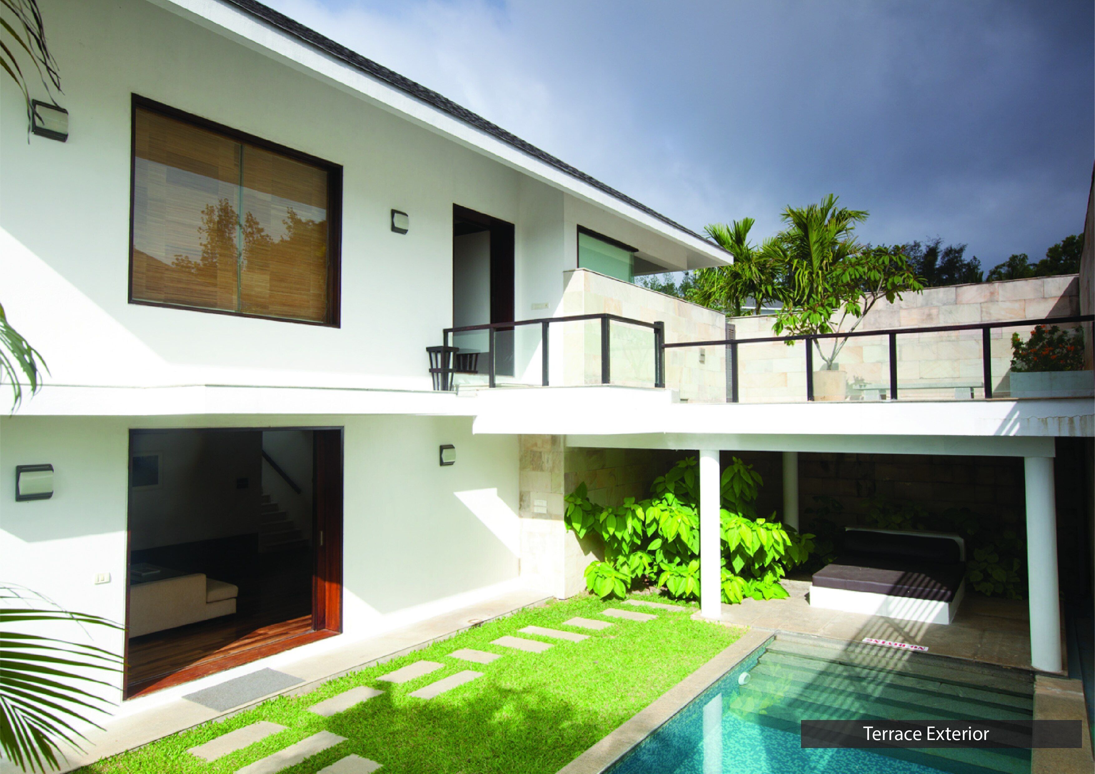 A modern two-story house with a terrace exterior, a swimming pool, and lush greenery.
