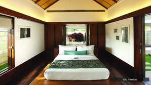A bedroom with a large bed, wooden ceiling, and a view of a garden through a window. - The Serai Chikmagalur (Chikkamagaluru)