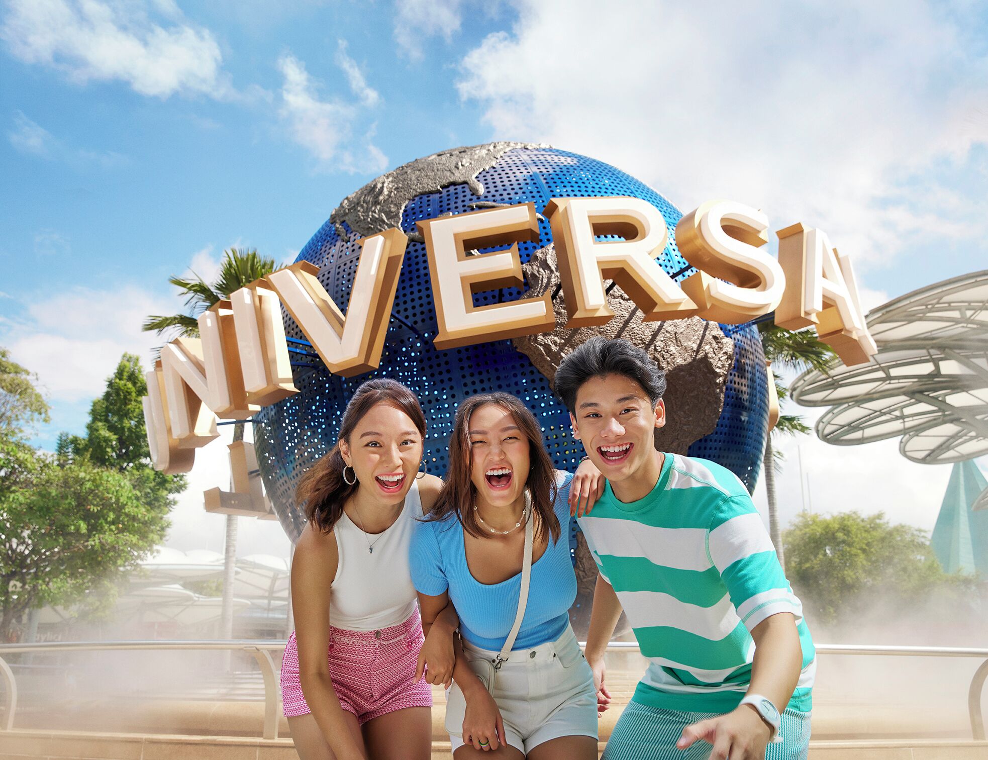 A group of people in front of a large, spherical structure with the word "UNIVERSAL" on it.