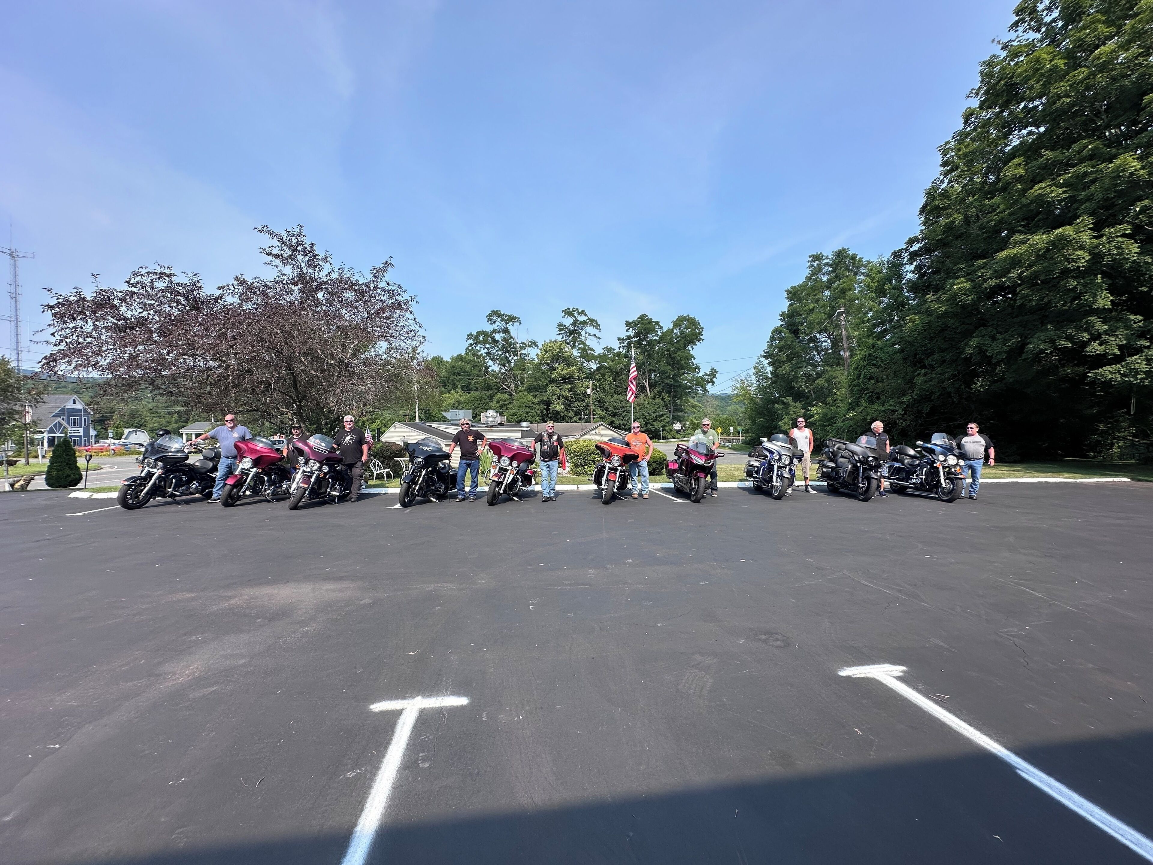 A parking lot with several motorcycles lined up.