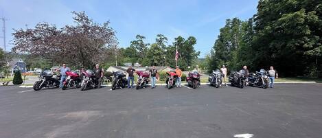 A parking lot with several motorcycles lined up.