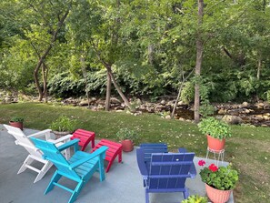 An outdoor seating area with Adirondack chairs and potted plants. - Cozy Corner Motel (Williamstown)