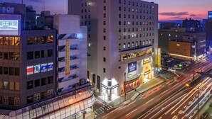 A multi-story hotel with a modern design, featuring a prominent entrance and signage for the "Airline Hotel." - Airline Hotel (Miyazaki)