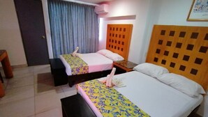 A hotel room with two beds, a wooden headboard, a bench, and a curtain. - Hotel Ziami (Veracruz)