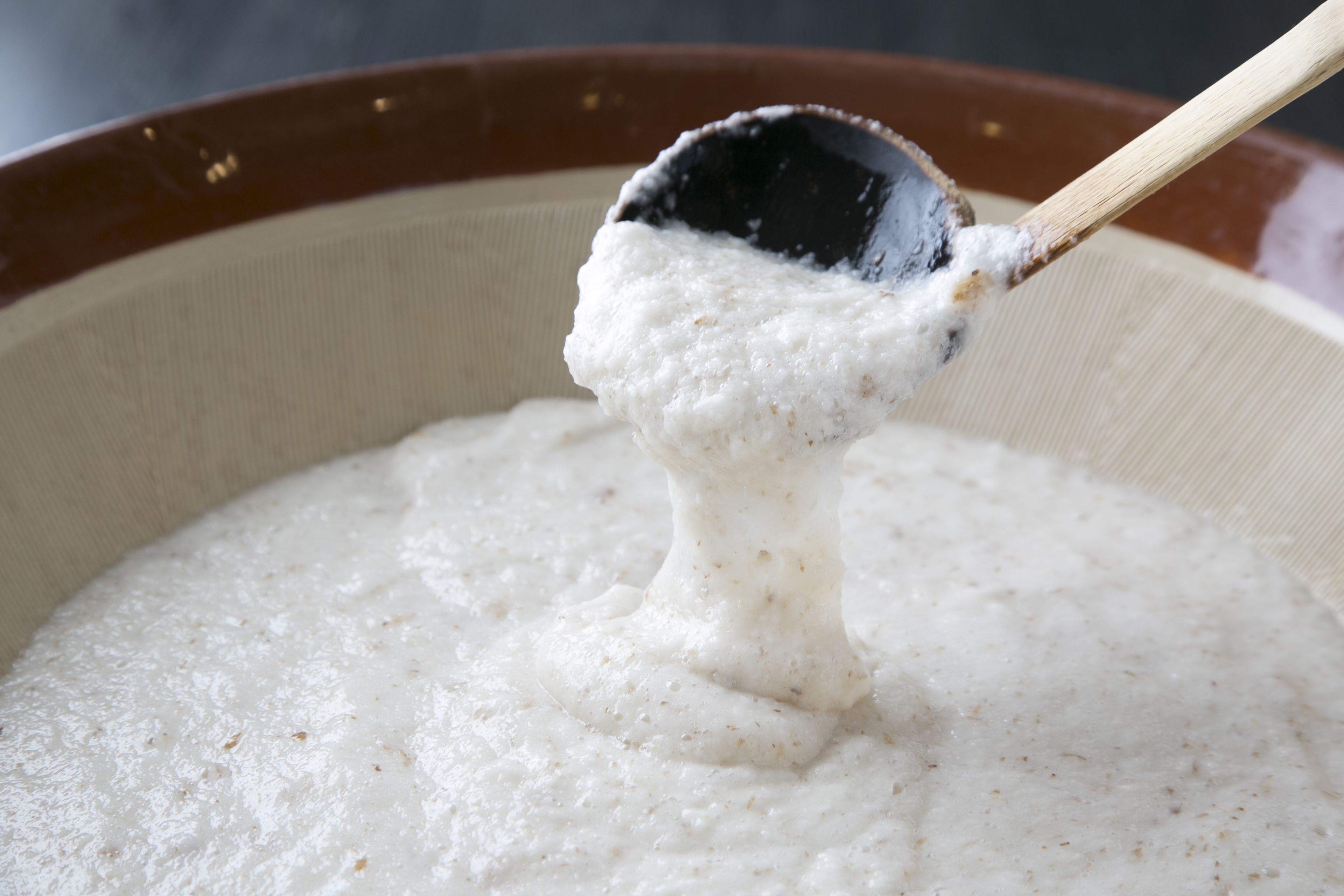 A close-up of a creamy substance being scooped with a spoon.