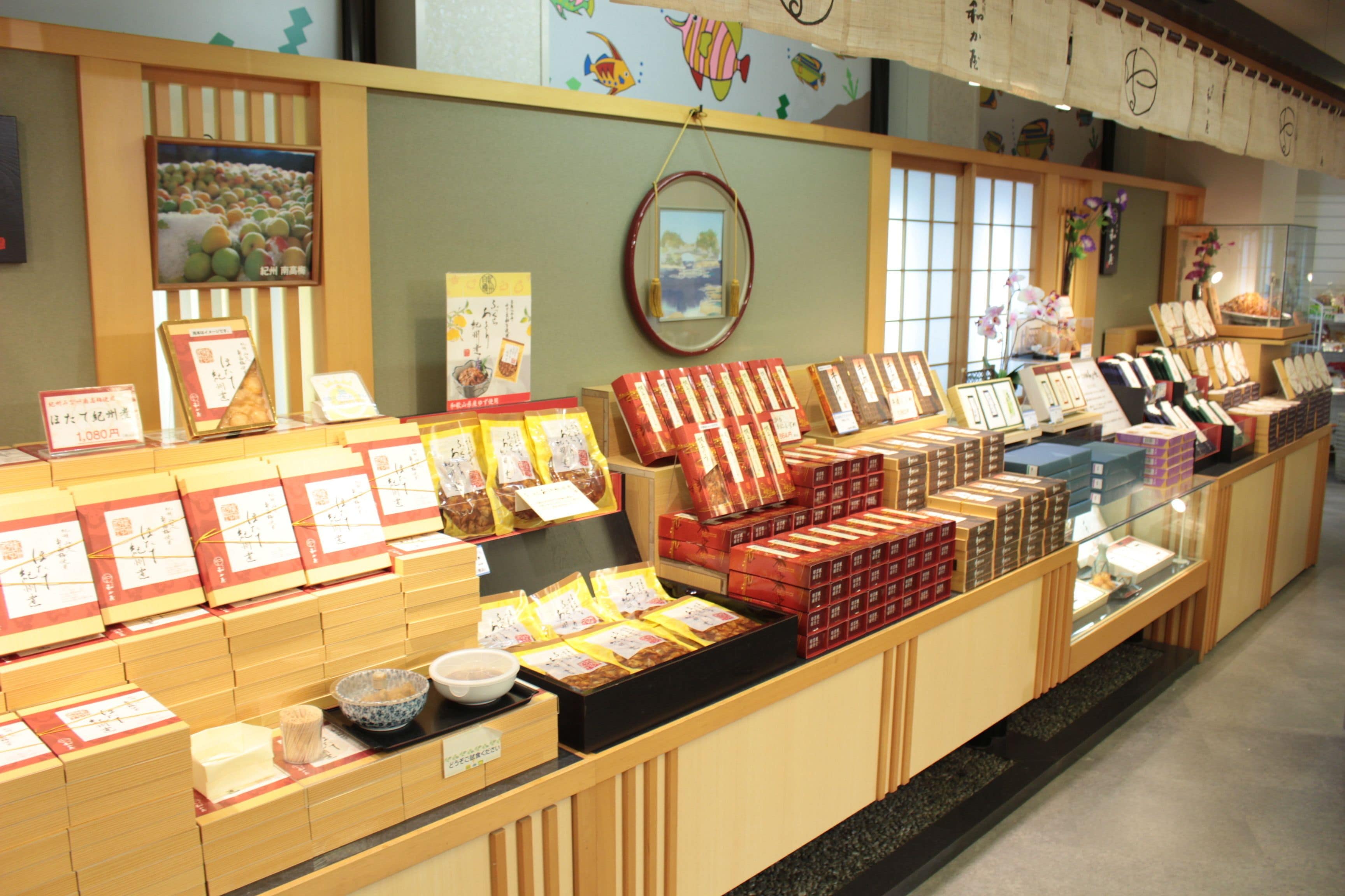 A display of packaged goods in a store with wooden shelves and a glass counter.