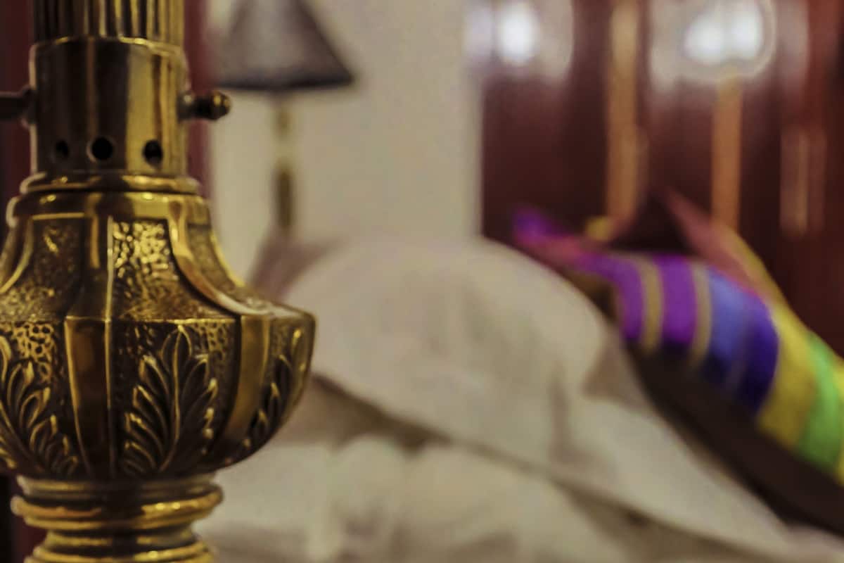 A brass lamp with intricate designs on a wooden surface.