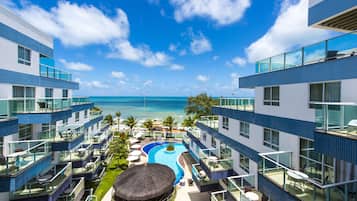 Una piscina al aire libre, sombrillas, tumbonas