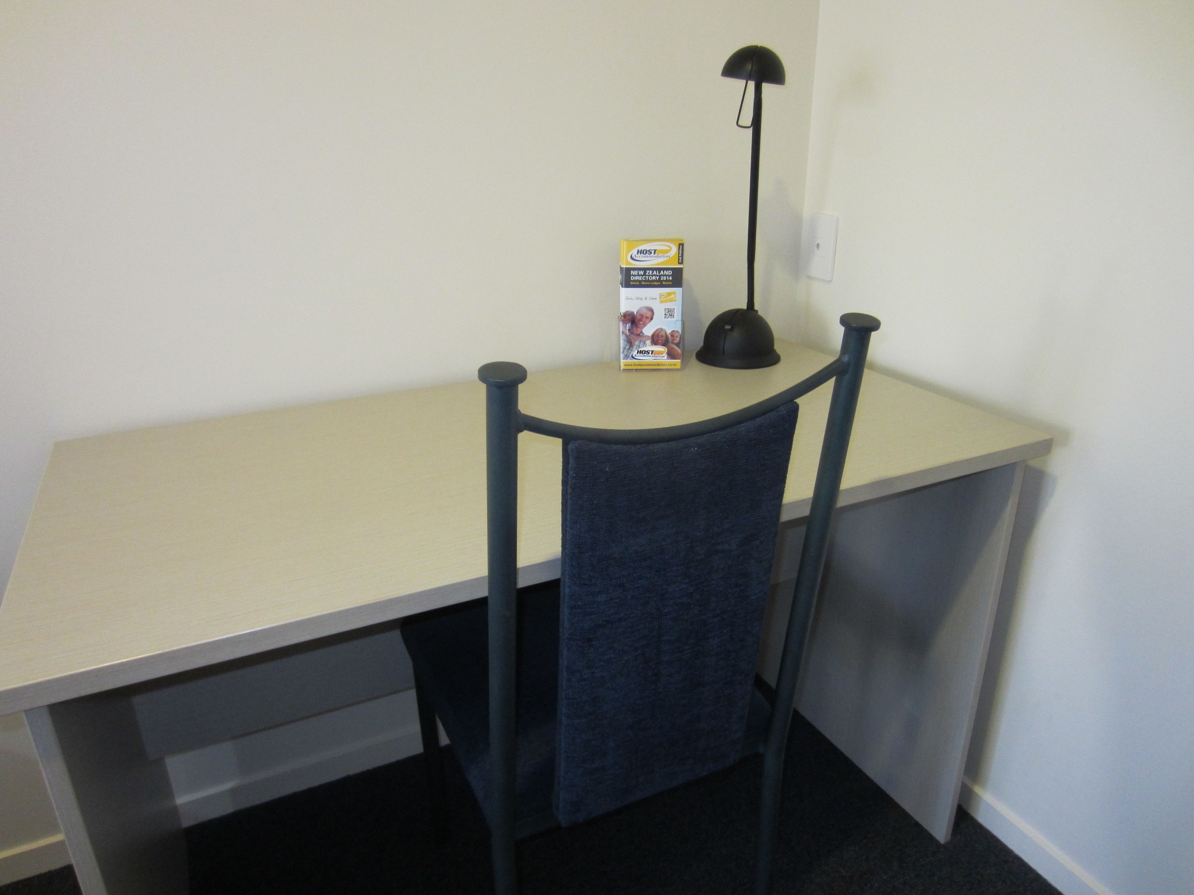 A desk with a chair, a lamp, and a box labeled "HOST".
