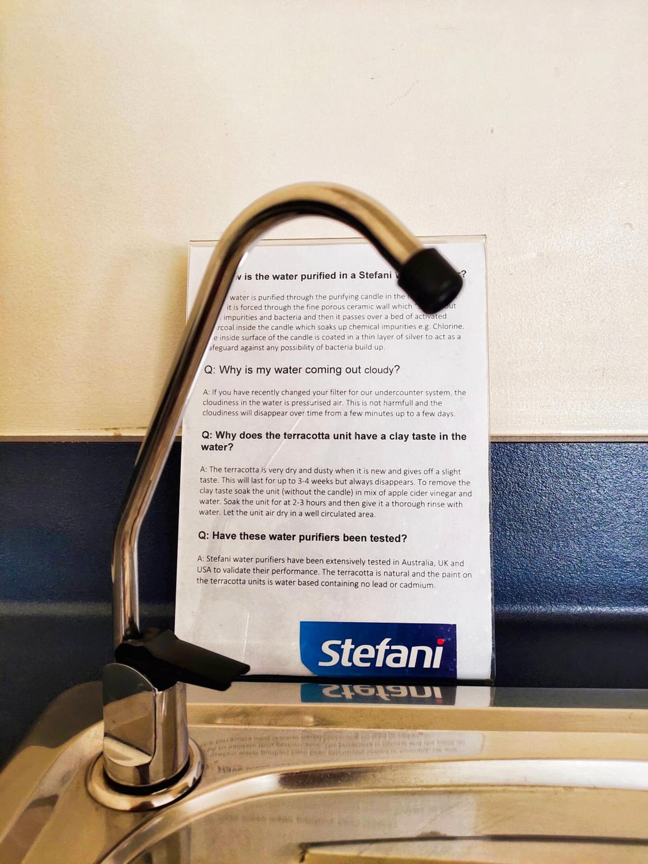 A water purifier with a manual and a question-and-answer sheet attached to it.