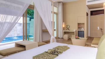 A modern hotel room with a large bed, a sitting area, a desk, and a view of a pool.