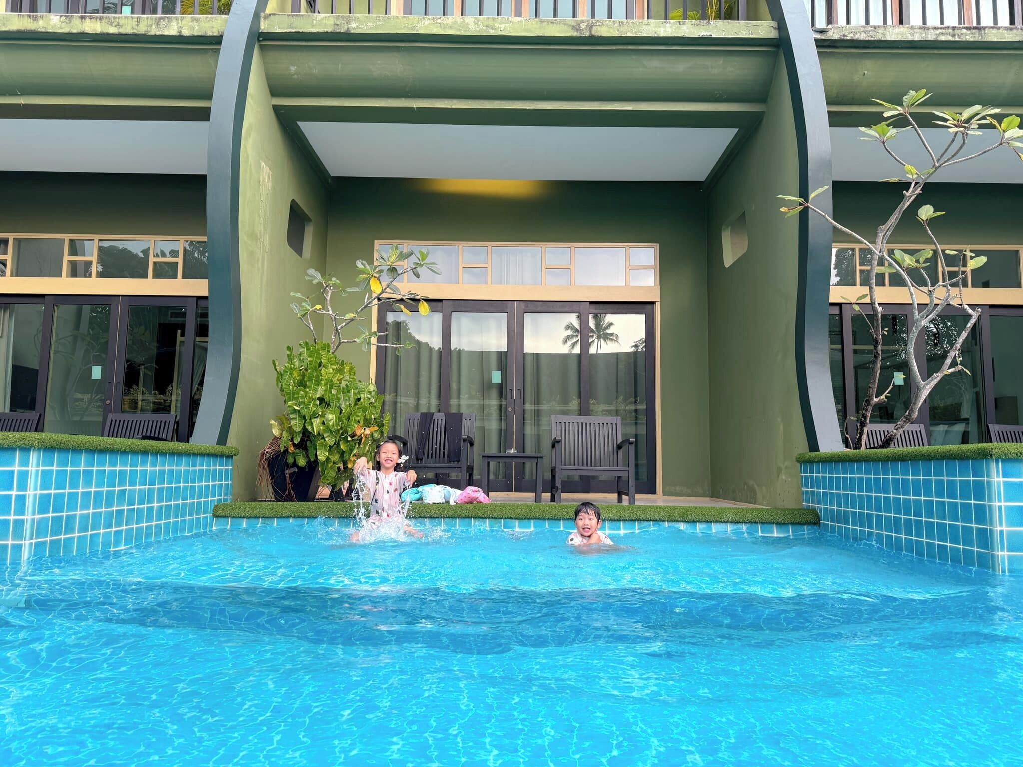 A swimming pool with a modern building in the background.