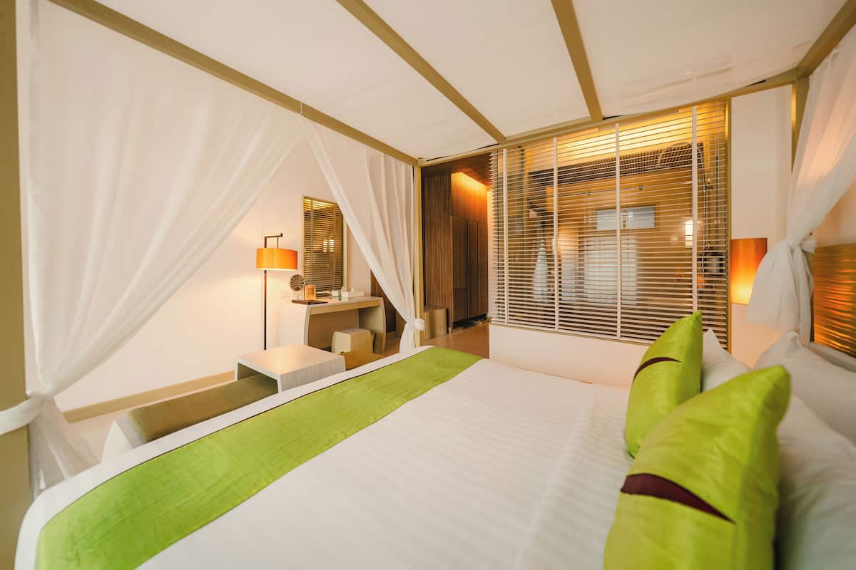 deluxe room, 1 king bed, pool access | in-room safe, individually furnished, desk, rollaway beds