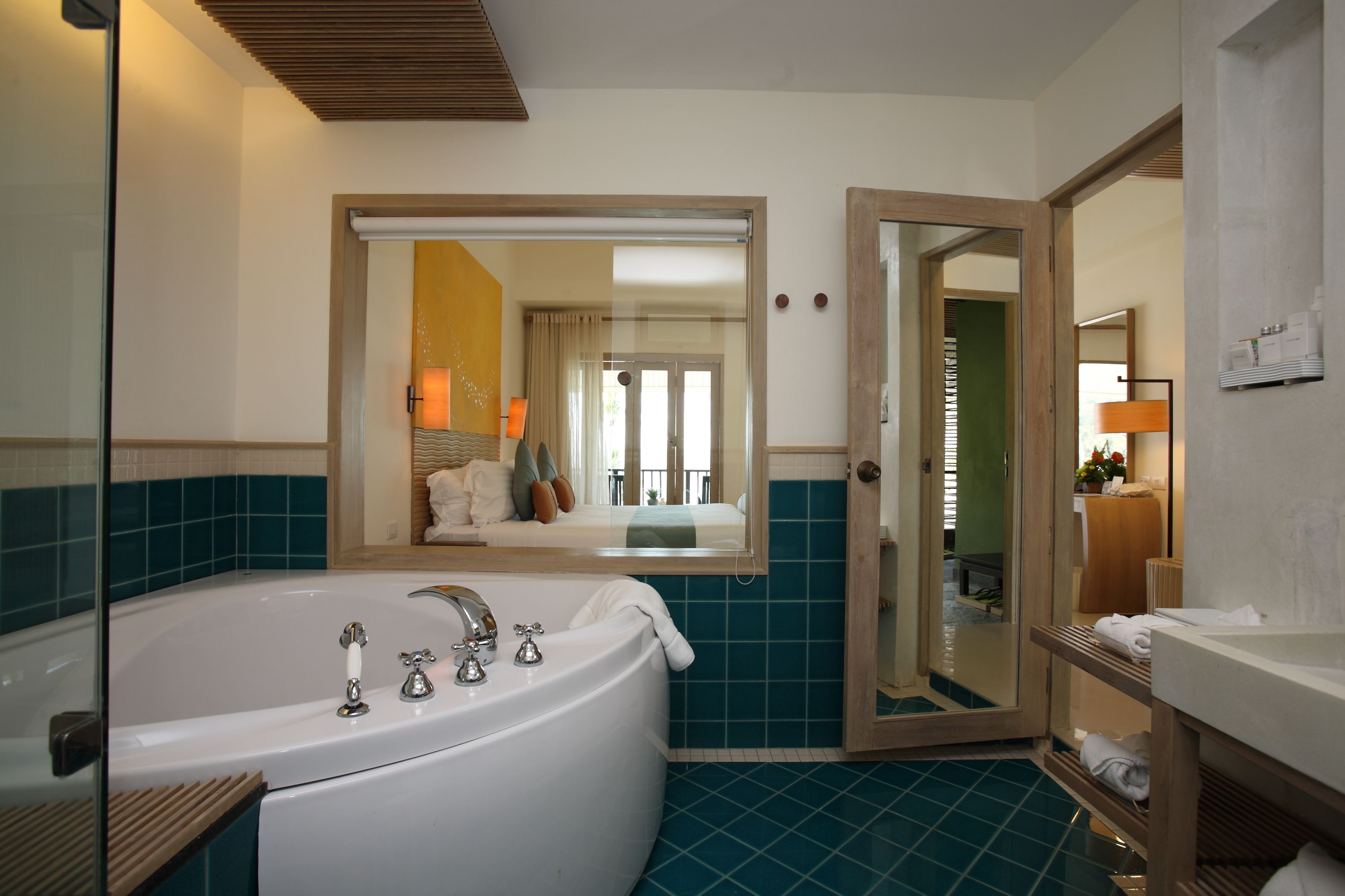Ein modernes Badezimmer mit einer großen Badewanne, einem Spiegel und einer Duschkabine.