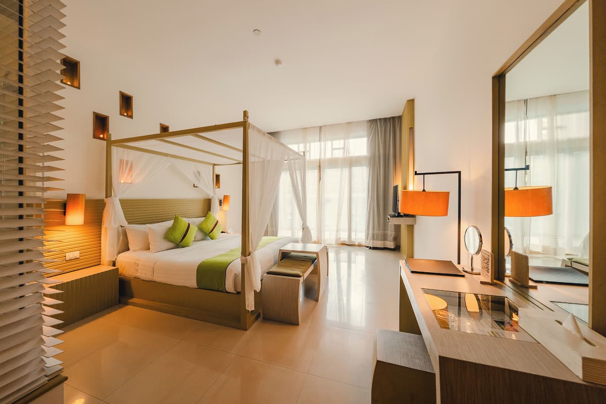 deluxe room, 1 king bed, pool access | in-room safe, individually furnished, desk, rollaway beds