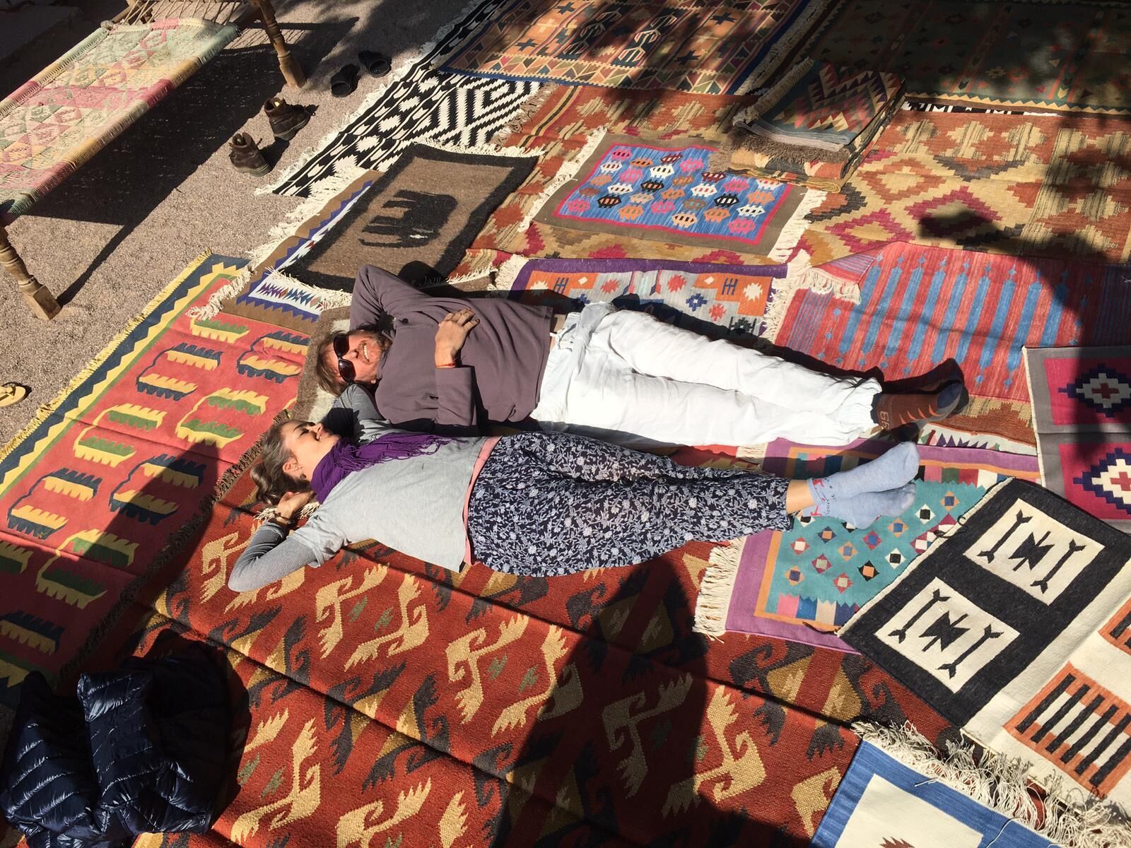 A room with a large, colorful rug featuring various patterns and designs.