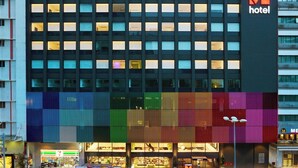 A modern hotel building with a prominent Citizen Hotel sign.