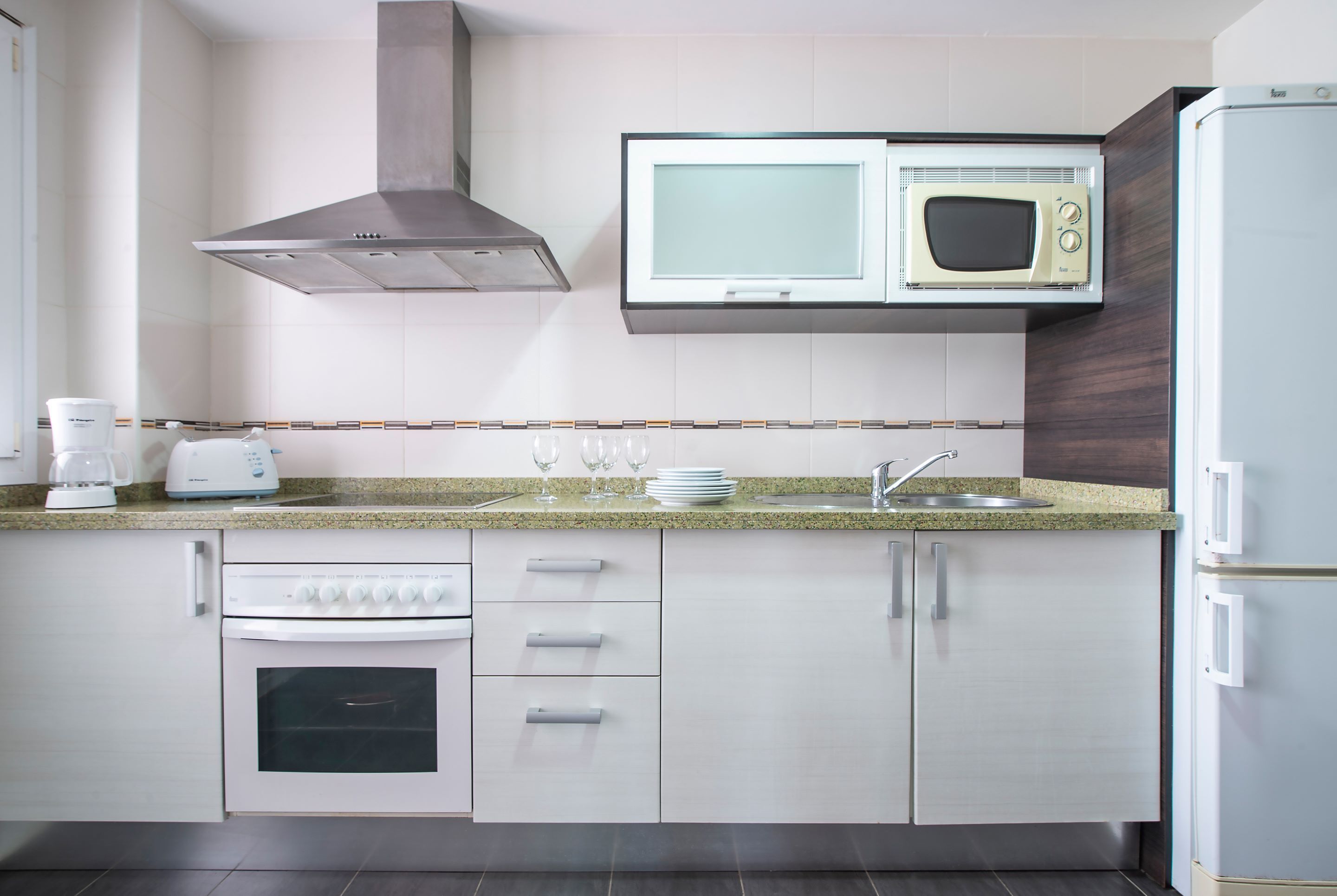 full-sized fridge, microwave, stovetop, cookware/dishes/utensils