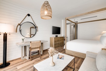 A modern interior with a dining area, kitchen, and large windows offering a city view. at Boulan South Beach