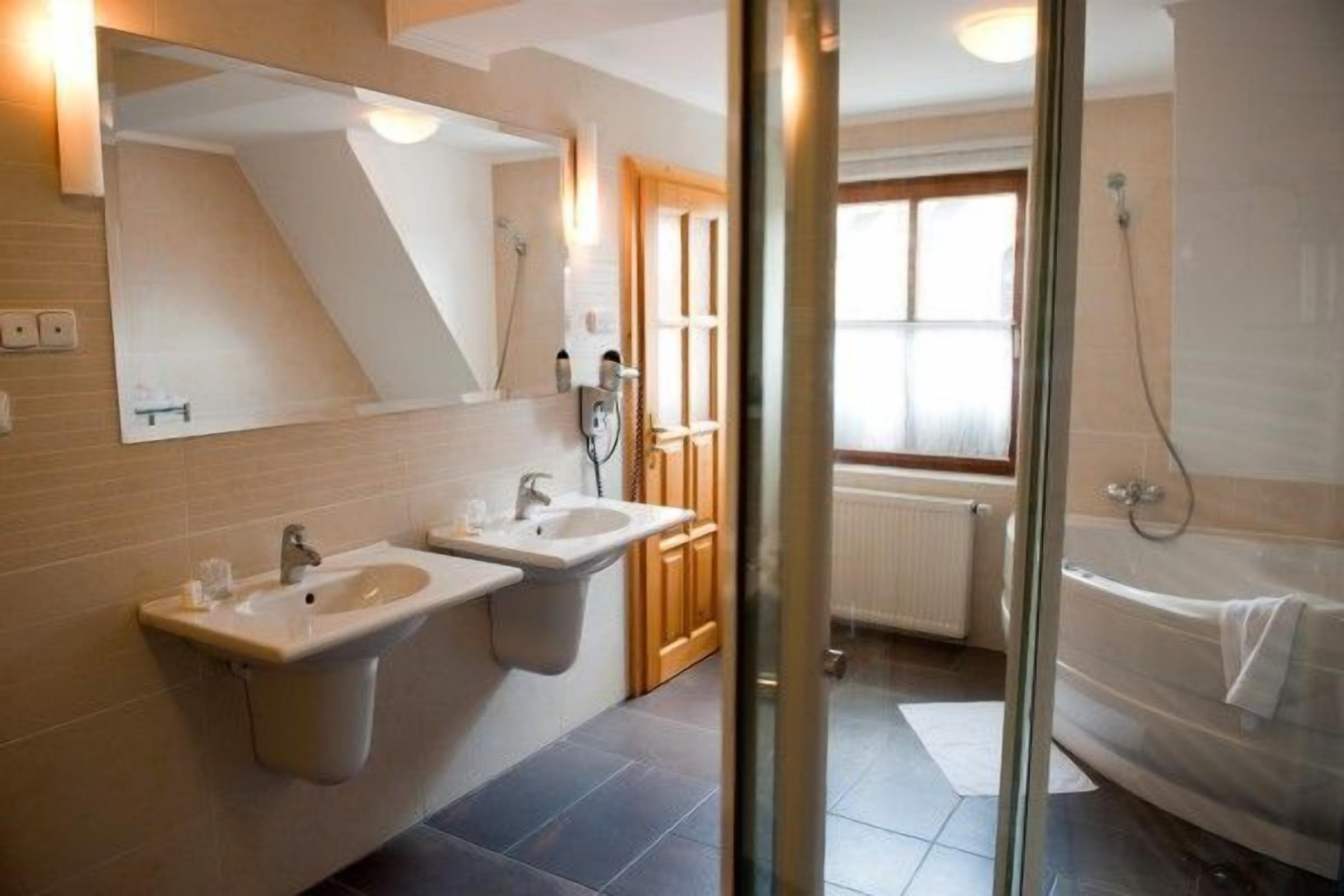 luxury suite | bathroom | deep-soaking bathtub, hair dryer, bathrobes, towels