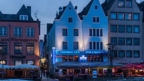 A hotel with a prominent sign, a traditional European architectural style, and a visible outdoor seating area. - Löwenbräu Köln Hotel & Restaurant (Cologne)