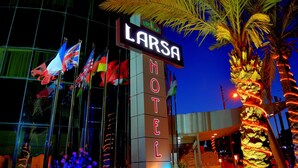A hotel sign with the name 'LARSA HOTEL' illuminated in neon lights. - Larsa Hotel (Amman)