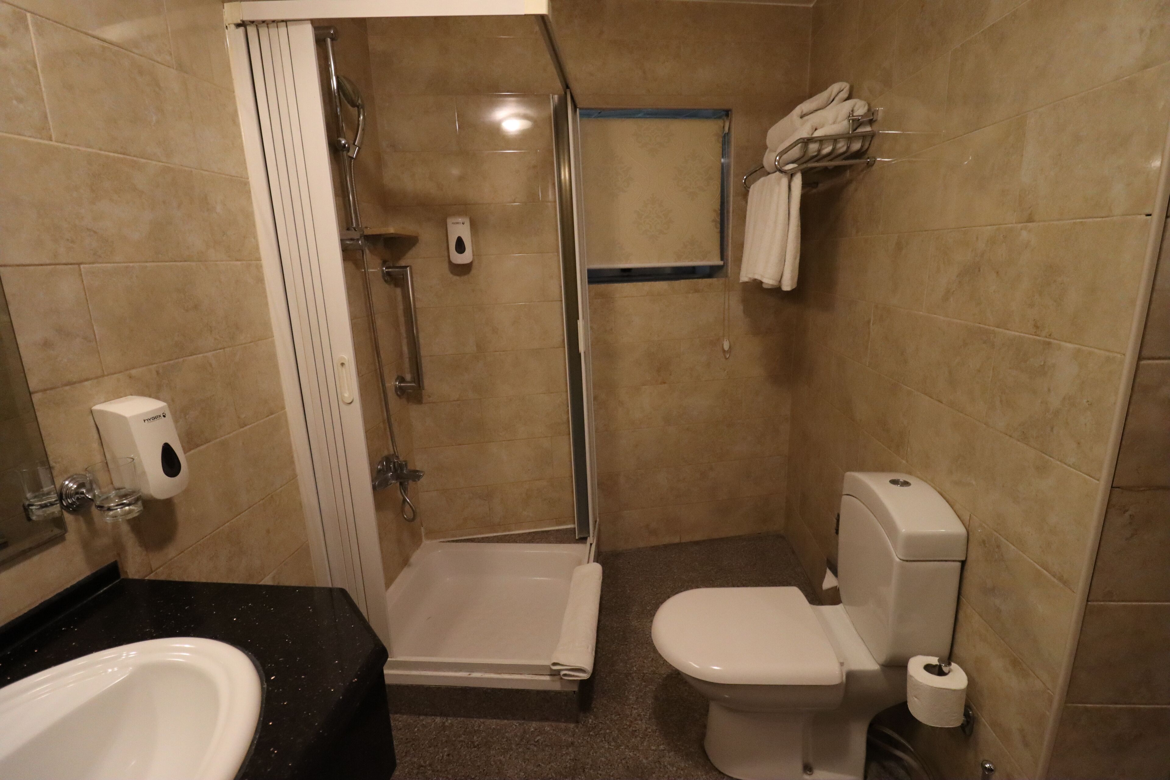 twin room, city view | bathroom | shower, hair dryer, slippers, towels