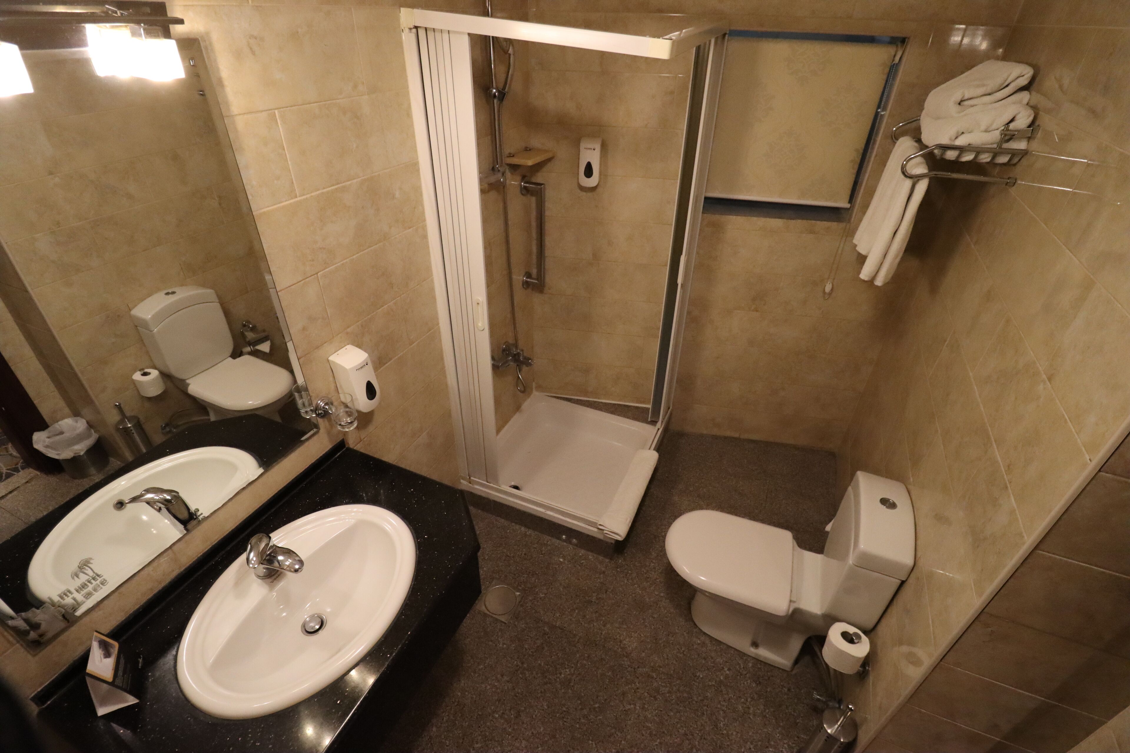 twin room, city view | bathroom | shower, hair dryer, slippers, towels