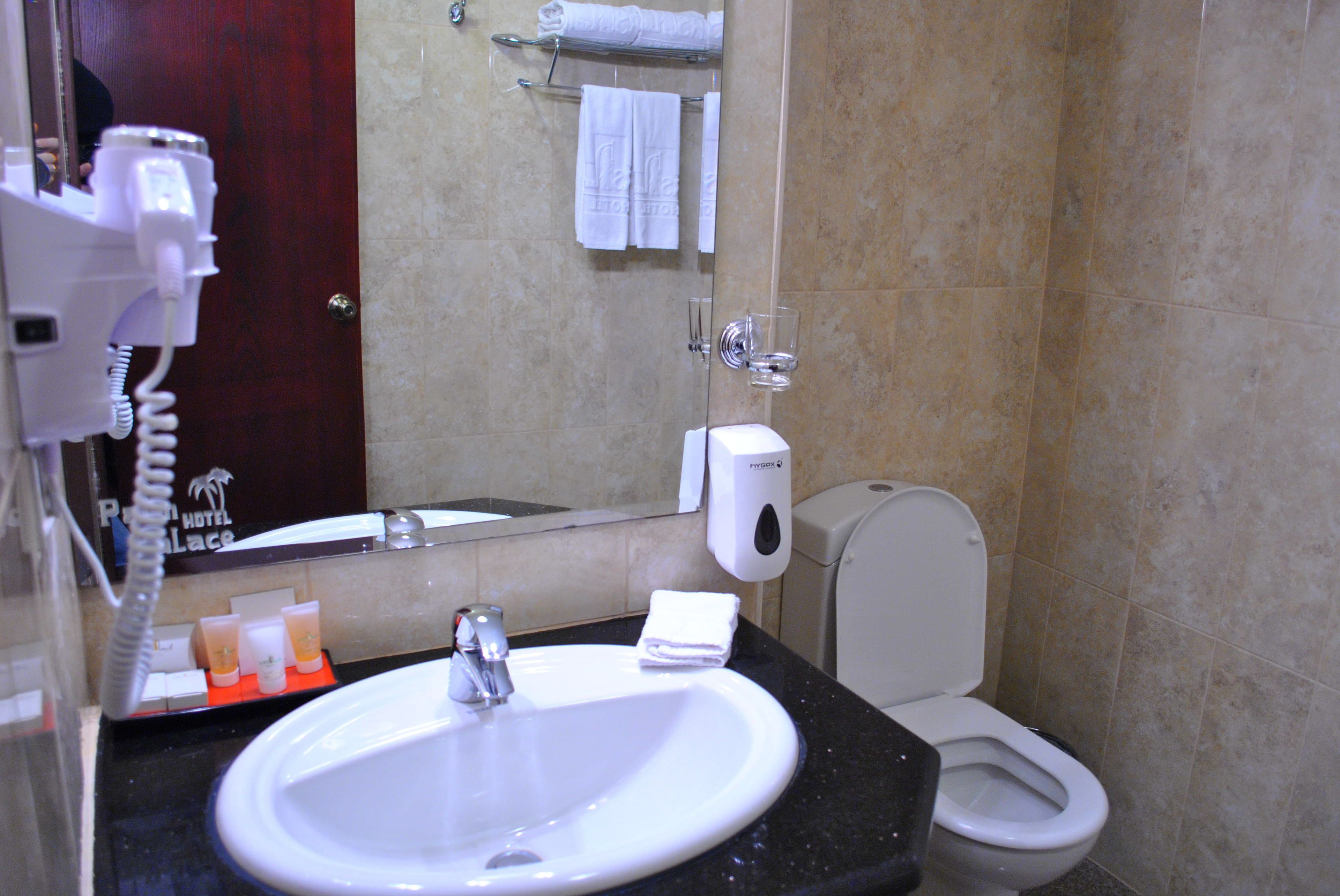 junior suite | bathroom | shower, hair dryer, slippers, towels