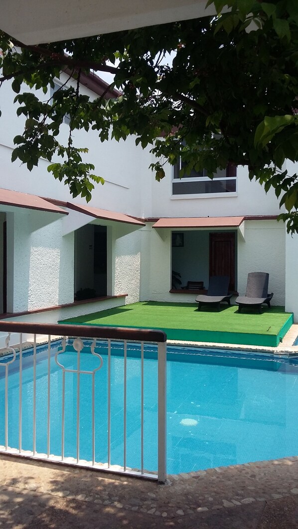 Outdoor pool, open 10 AM to 9 PM, pool loungers