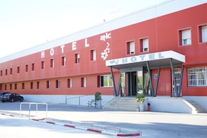 A red building with the word "HOTEL" prominently displayed on the facade.