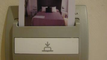 A hotel card reader with a card inserted, displaying 'hotel ortuella'.