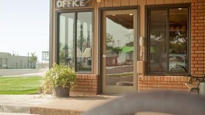 A building with a sign reading "OFFICE" and a wooden ceiling. - Oregon Trail Inn (Buhl)