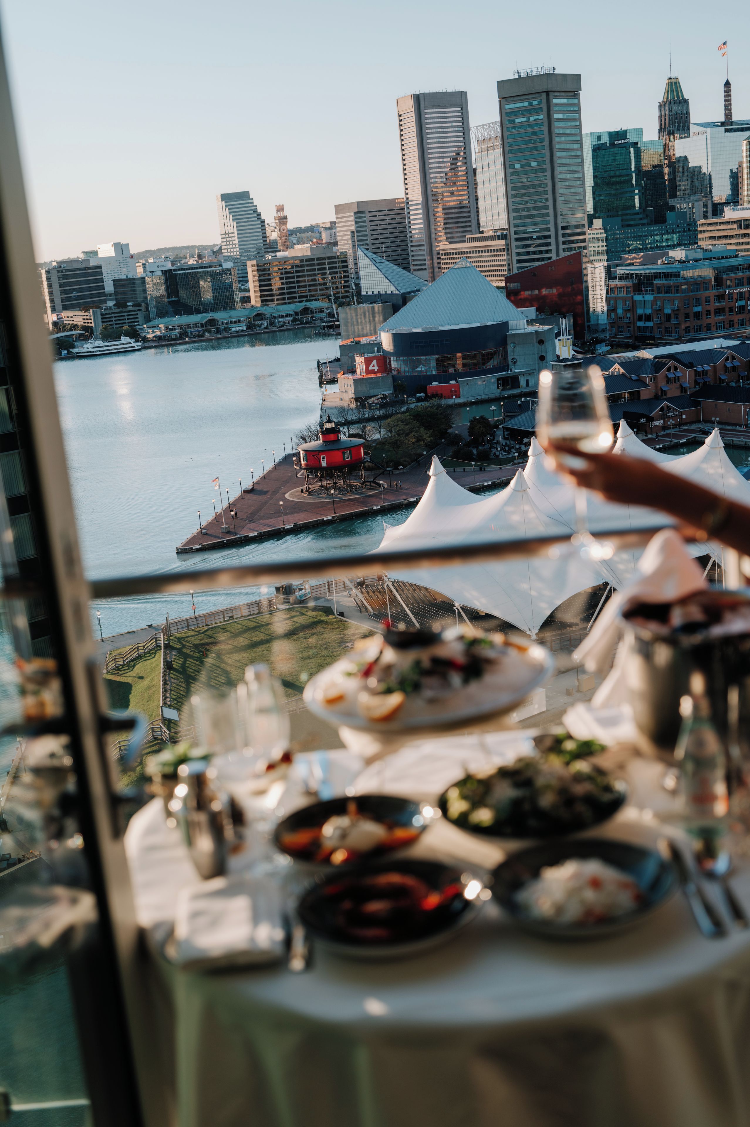 A table set for dining with a cityscape view in the background.