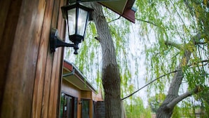 A wooden building with a large tree in front. - Perricoota Vines Retreat (Moama)