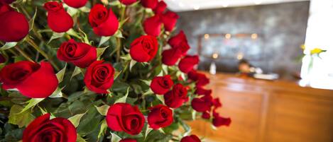 A bouquet of red roses in a hotel lobby.