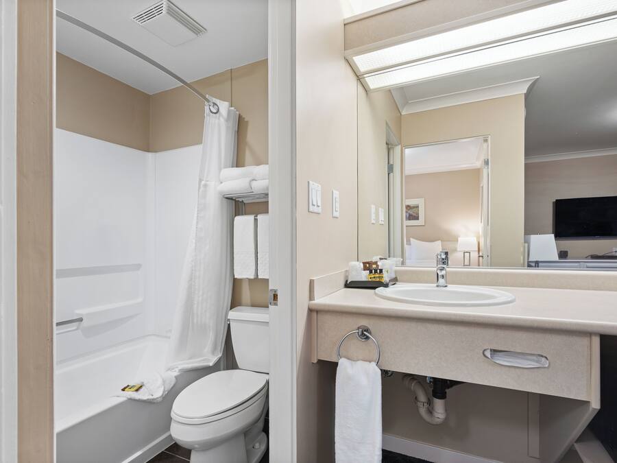 A modern bathroom with a bathtub, toilet, and sink.