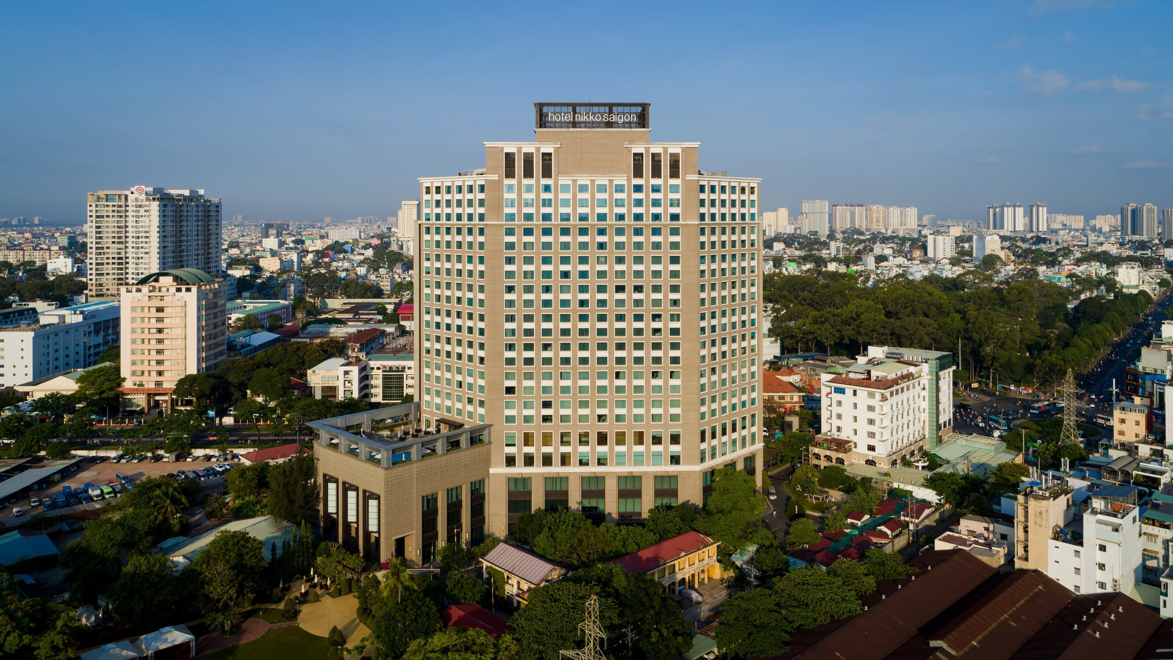 A high-rise hotel with a modern design, featuring a prominent sign at the top.