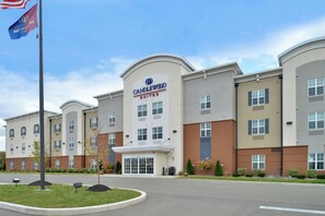 A hotel with a prominent 'Candlewood Suites' sign, multiple windows, and a landscaped entrance area. - Candlewood Suites Elmira Horseheads by IHG (Horseheads)