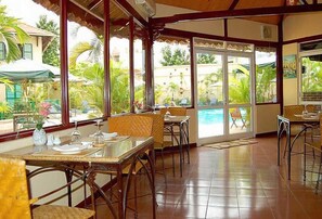 Breakfast, lunch served; local and international cuisine, pool views