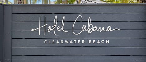 A wooden sign with 'Hotel Cabana' and 'Clearwater Beach' written on it.