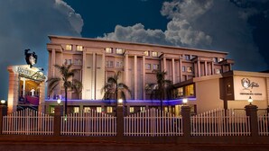 A hotel with a prominent entrance, a conference center, and a well-lit facade. - Apollo Hotel (Randburg)