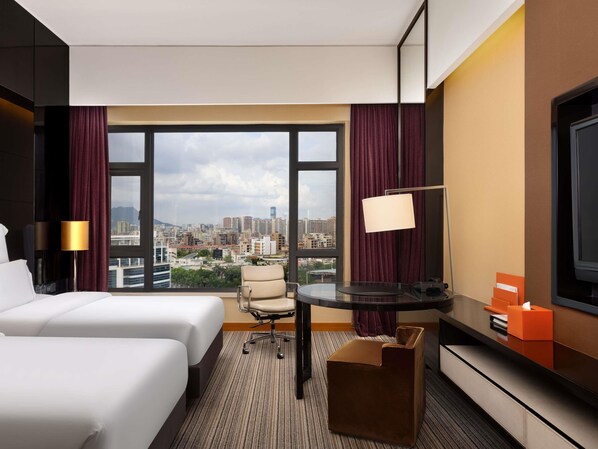 A hotel room with two beds, a desk, a chair, a TV, and a view of the cityscape. - Pullman Dongguan Changan (Dongguan)
