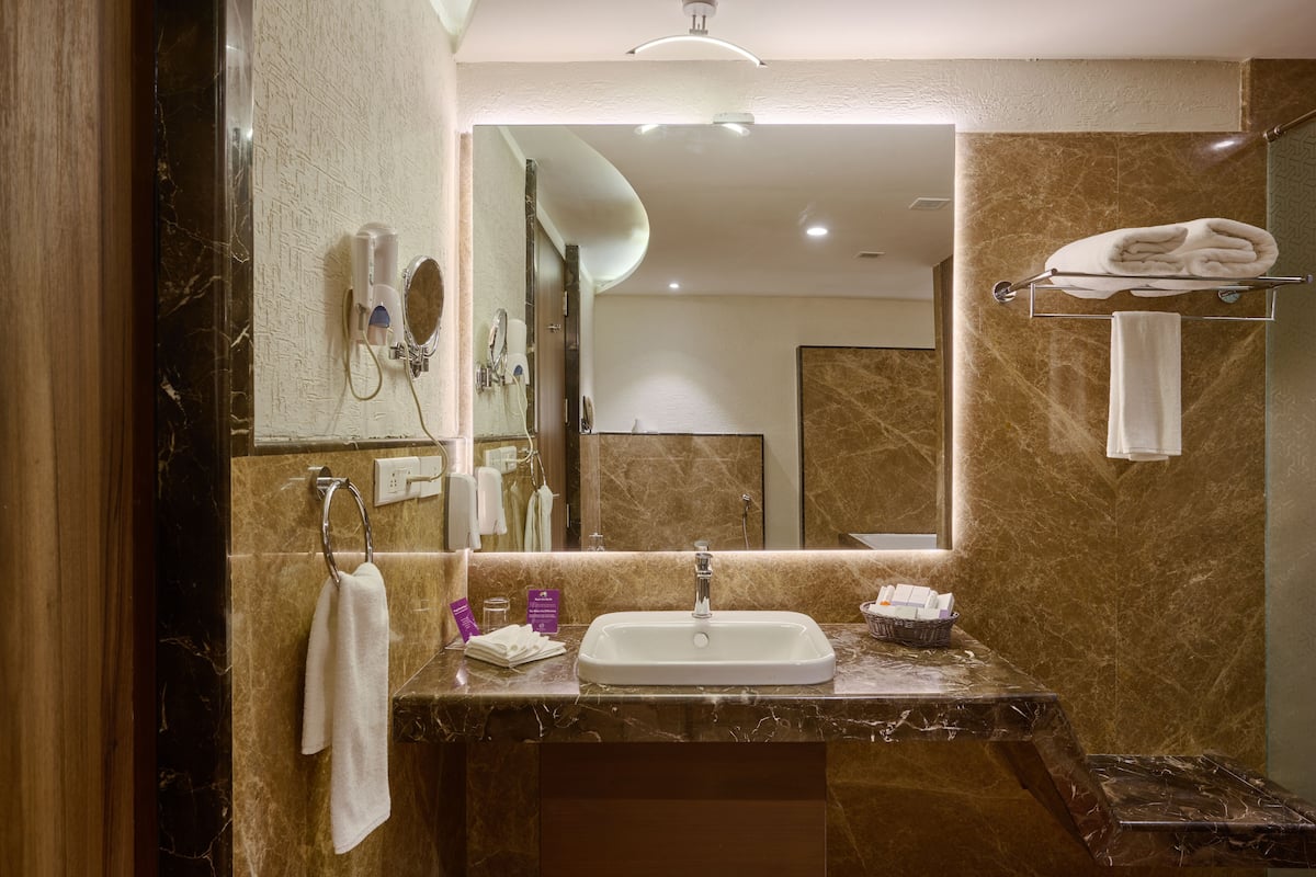 flora suite with complimentary airport transfers | bathroom | designer toiletries, hair dryer, bathrobes, slippers