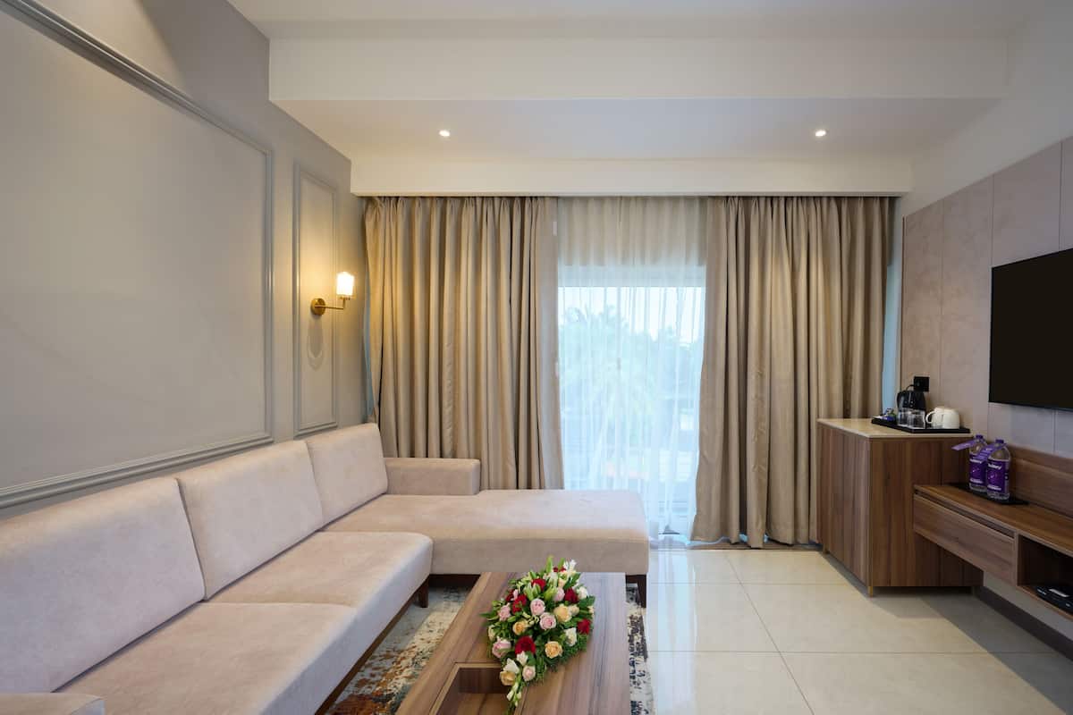 flora suite with complimentary airport transfers | living area | 32-inch lcd tv with satellite channels, tv, ping pong