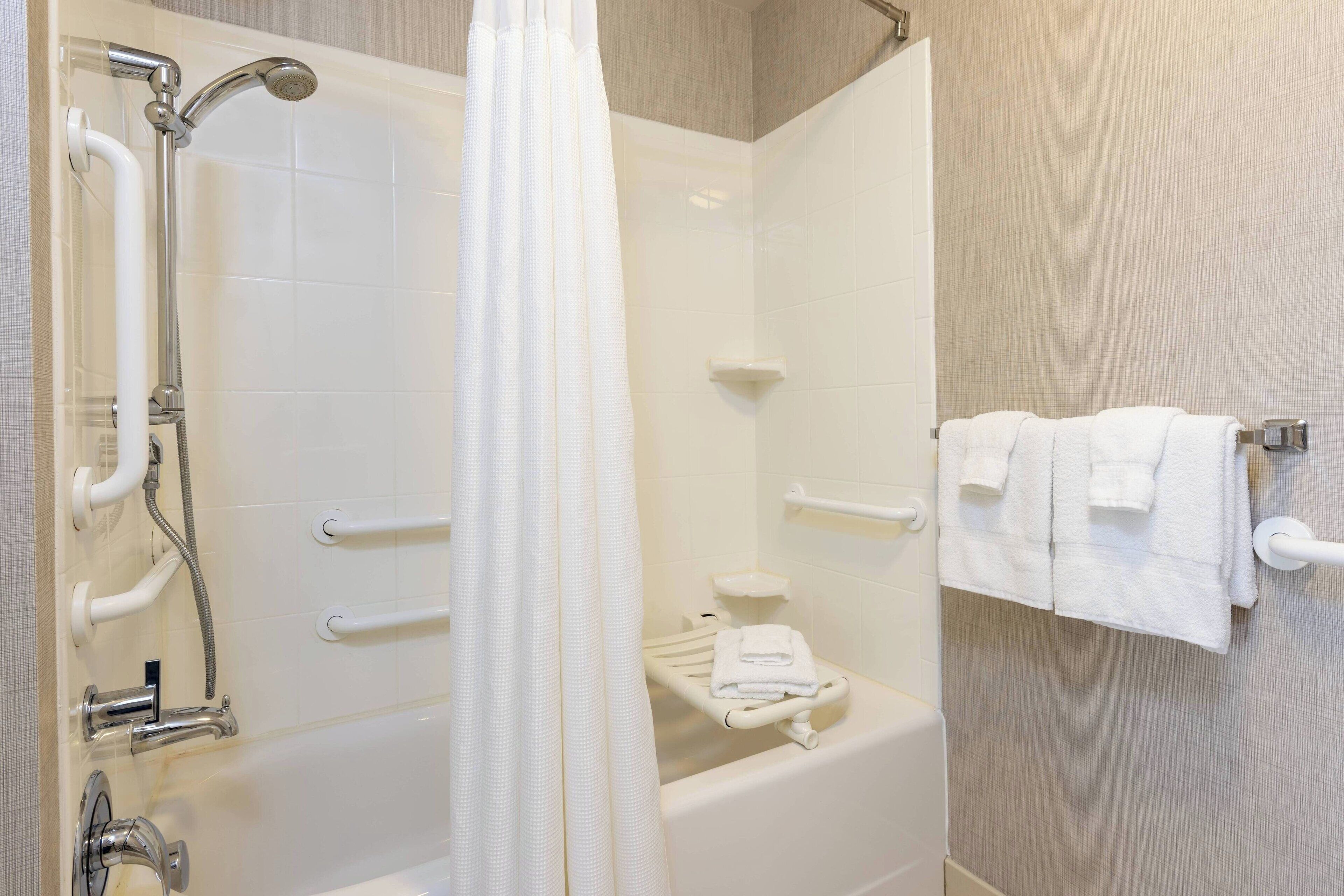 combined shower/bathtub, designer toiletries, hair dryer, towels